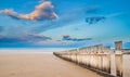 Wooden fence on empty beach at sunset Royalty Free Stock Photo