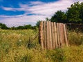 Wooden fence in a field on a sunny summer day. Royalty Free Stock Photo