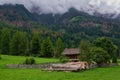 Wooden fence in front of a forest house with mountains and trees in San Candido, South Tyrol, Italy. Royalty Free Stock Photo