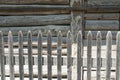 Wooden fence in front of the wooden wall of the house Royalty Free Stock Photo