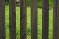 Wooden fence with gaps between the boards. courtyard behind the fencing Royalty Free Stock Photo