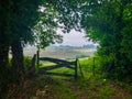 Wooden fence with a green grass meadow at the background. Camino de Santiago Primitivo Royalty Free Stock Photo