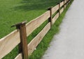 Wooden fence and green meadow, diagonally
