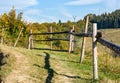 Wooden fence on hillside near forest