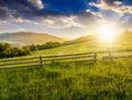 Wooden fence on hillside at sunrise Royalty Free Stock Photo