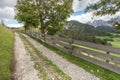 Wooden fence long a secondary mountain white street in Val di Funes Royalty Free Stock Photo