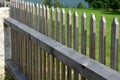 Wooden fence made of natural planks. the columns are made of roughly worked gray granite. fencing land in the mountains. meadow tr Royalty Free Stock Photo