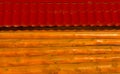 Wooden fence made of solid timber with red roof