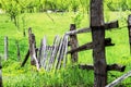 Wooden fence on meadow as a border from the garden