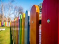 Wooden fence painted in different colors Royalty Free Stock Photo