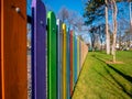 Wooden fence painted in different colors Royalty Free Stock Photo