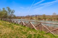 Wooden fence and park along Tanaro river. Royalty Free Stock Photo