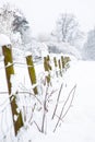 Wooden fence posts and barbwire in a blizzard in Surrey, UK Royalty Free Stock Photo