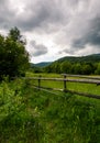 Wooden fence on a rural meadow in mountains Royalty Free Stock Photo