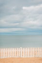 Wooden Fence in Sand on Beach. Royalty Free Stock Photo