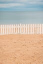 Wooden Fence in Sand on Beach. Royalty Free Stock Photo