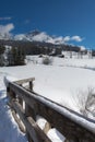 Wooden Fence and Snow-covered Firs in a Snowy Mountain Panorama Royalty Free Stock Photo