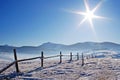 Wooden fence in snowcovered mountains