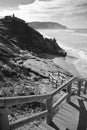 Wooden fence with stairs on atlantic coast leading to ocean