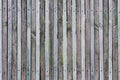 Wooden fence from thin planks, fixed by nails and screws, many knots, cracks, scratches and slits on junction, natural colors, des