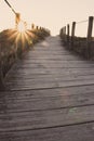 Wooden fence and walkway to beach faded. Empty path in sunlight. Walking concept. Camino de Santiago way. Royalty Free Stock Photo