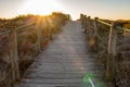Wooden fence and walkway to beach. Scenic sunset on seashore. Walking concept. Camino de Santiago way. Royalty Free Stock Photo