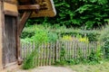 Wooden fence and wildflowers with green trees in the background Royalty Free Stock Photo