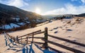 Wooden fence by in winter rural area Royalty Free Stock Photo