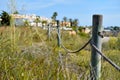 Wooden fencing with rope along pathway