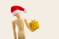 Wooden figure with gift box on white background Royalty Free Stock Photo