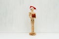 Wooden figure - art mannequin with red Santa hat with gift box Royalty Free Stock Photo