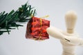 Wooden figure doll and red gift box on the white backgound Royalty Free Stock Photo