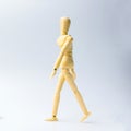 Wooden figure doll with walking action for business concept on w Royalty Free Stock Photo