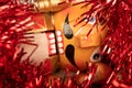 Wooden figure in the form of a soldier for chopping nuts surrounded by colored tinsel and hazelnuts in bulk. New year and Royalty Free Stock Photo