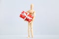 Wooden figure with gift box Royalty Free Stock Photo