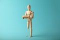 Wooden figure of man with artificial prosthetic leg. Amputee and disability concept Royalty Free Stock Photo