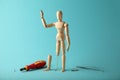 Wooden figure of man with artificial prosthetic leg. Amputee and disability concept Royalty Free Stock Photo