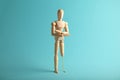 Wooden figure of man with artificial prosthetic leg. Amputee and disability concept