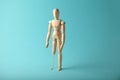 Wooden figure of man with artificial prosthetic leg. Amputee and disability concept