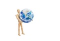 Wooden figure mannequin holding planet earth globe isolated on white background. Royalty Free Stock Photo