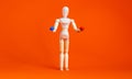 Wooden figure of a mannequin holding a red pill and blue pill on a orange background. Coronavirus, pandemic and epidemic concept.