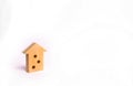 Wooden figure of a multi-storey house on a white background. Three-story house. Buying and selling of real estate, construction. A