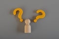 Wooden figure and question mark symbols Royalty Free Stock Photo