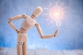 Wooden figure showing light bulb symbol Royalty Free Stock Photo