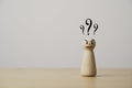 Wooden figure standing with question mark for question and answer time concept