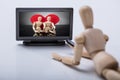 Wooden Figure Watching Television Royalty Free Stock Photo