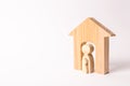 A wooden figure of a woman in a house with a child. The concept of pregnancy in women. Pregnant mother. Childbirth at home.