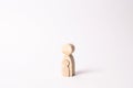 A wooden figure of a woman with a small child. The concept of a woman`s pregnancy, the bearing of a child Royalty Free Stock Photo