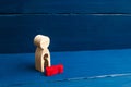 A wooden figure of a woman with a void from which a red child fell. The concept of the loss of a child, abortion of pregnancy, mis Royalty Free Stock Photo