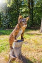 Wooden figure wood carving of a lynx in the forest